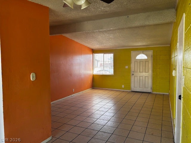 3708 Perliter Avenue, North Las Vegas, NV 89030 Tiled flooring spans this open interior entryway showcasing structural ceiling beams.