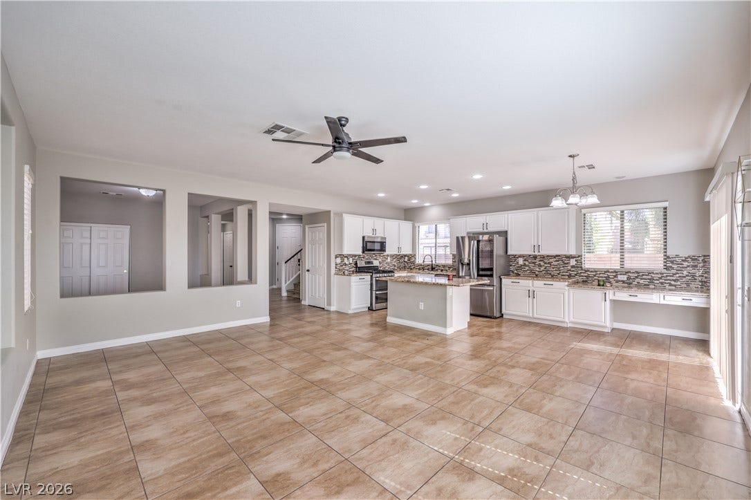 Tiled flooring flows through this airy, open-concept kitchen and living area.