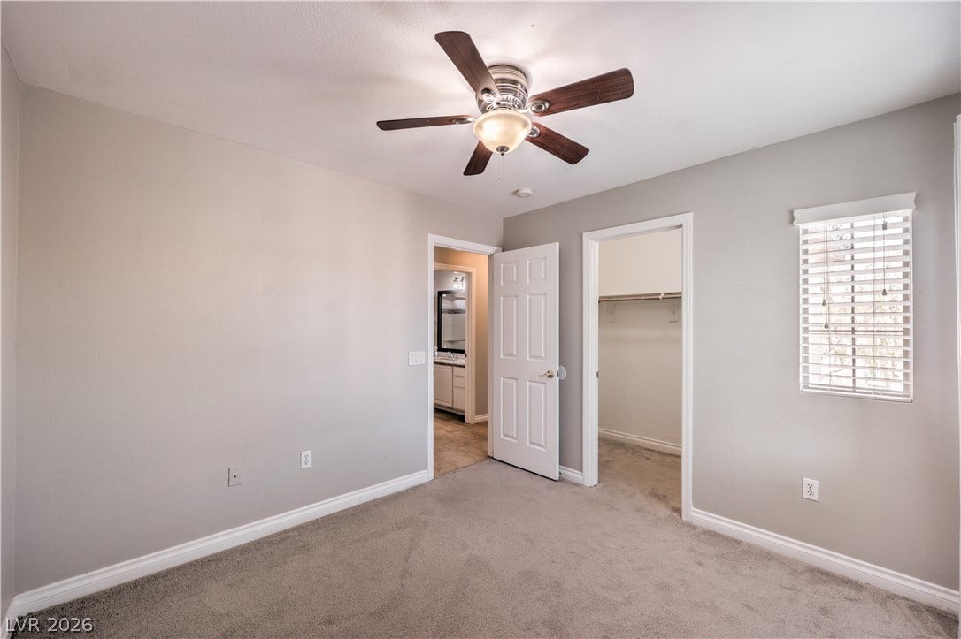 Plush carpeting and an attached walk-in closet highlight this comfortable bedroom space.