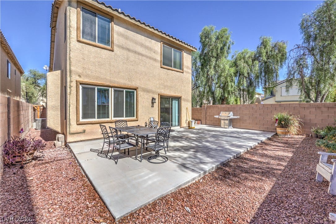 An expansive concrete patio provides the perfect setting for outdoor dining and entertaining.