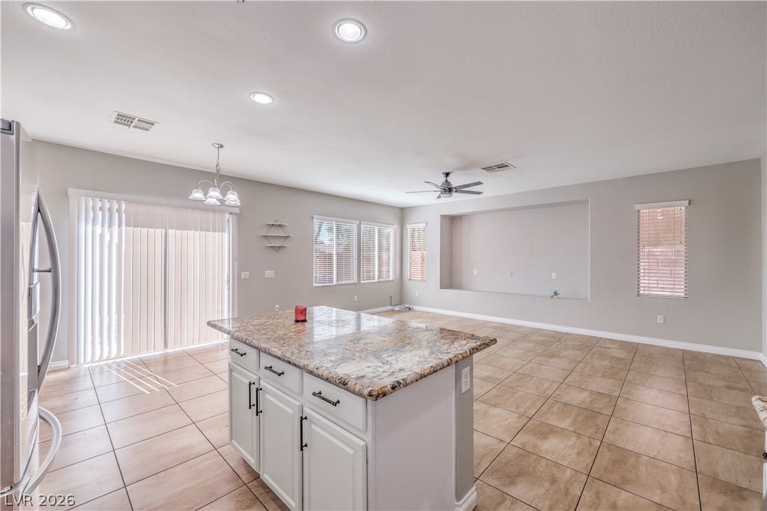 An open floorplan seamlessly connects the kitchen island to a spacious living area.