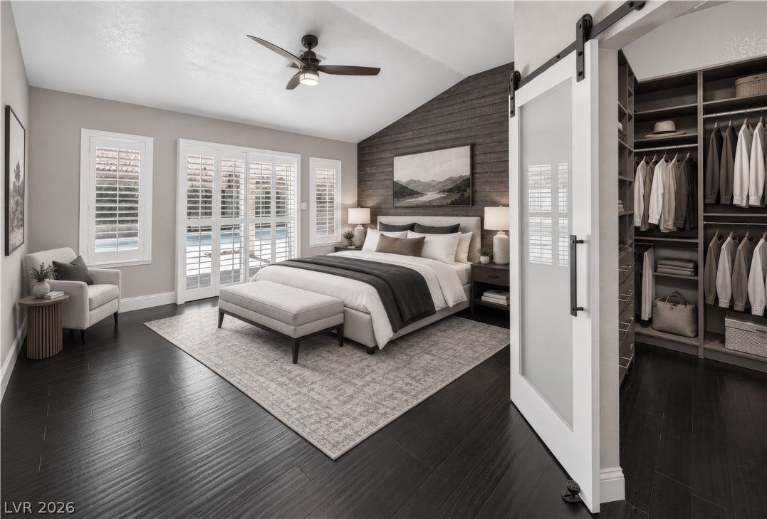 1740 Bluffs Drive, Henderson, NV 89014 This photo is virtually staged. Vaulted ceilings and rich wood flooring define this elegant primary suite with custom built-in closets.
