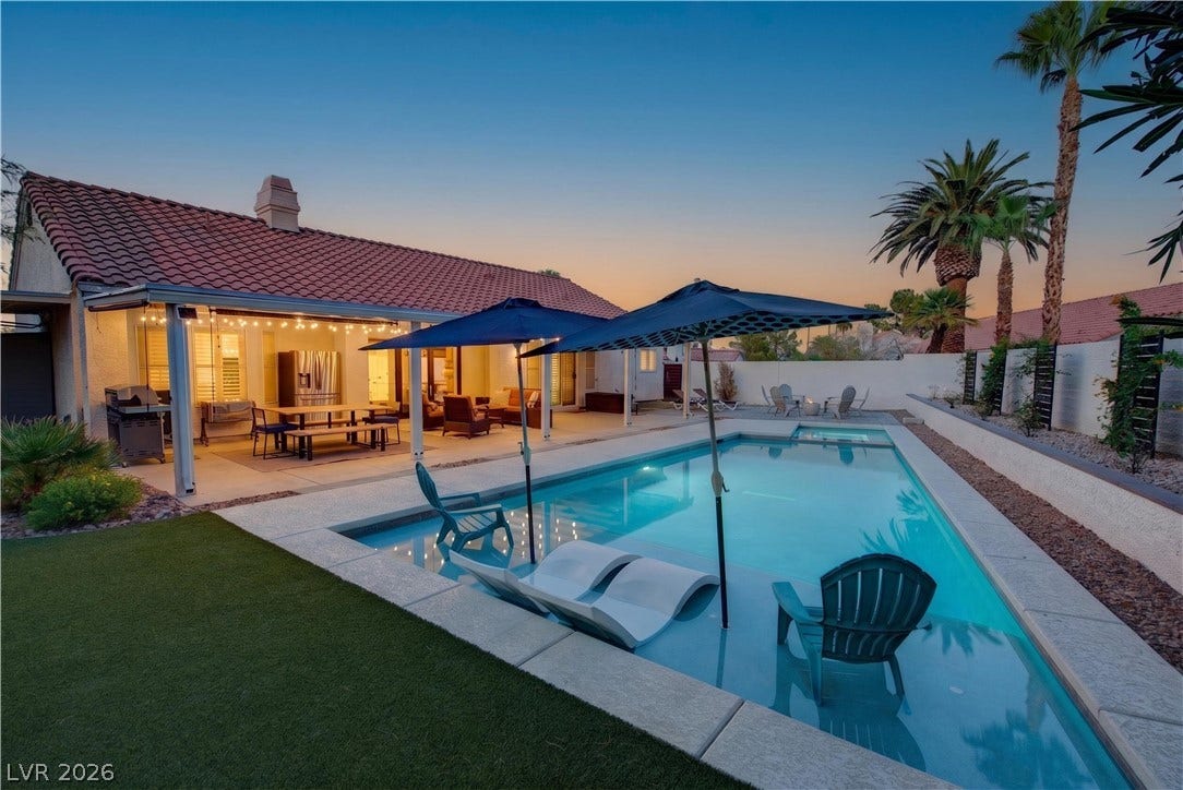 1740 Bluffs Drive, Henderson, NV 89014 An inviting backyard oasis features a pristine swimming pool beneath a classic tile roof.