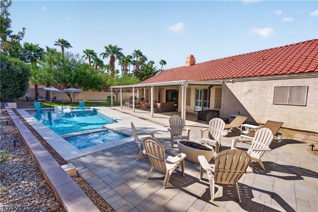 1740 Bluffs Drive, Henderson, NV 89014 A spacious stone patio surrounds the sparkling pool and integrated spa in this private backyard.