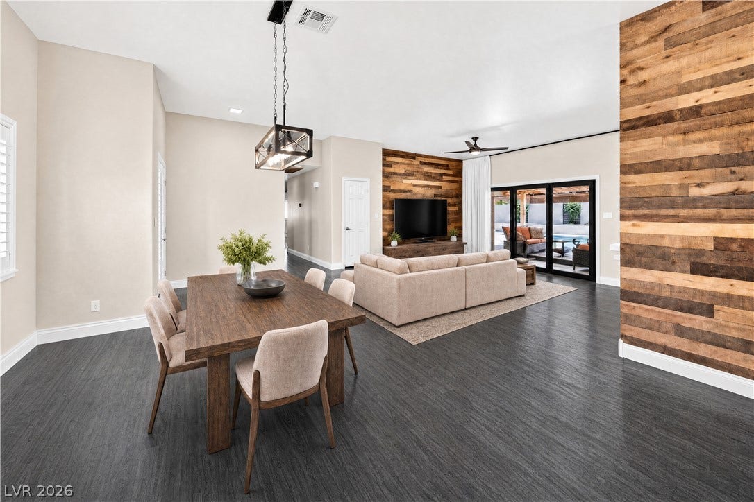 1740 Bluffs Drive, Henderson, NV 89014 Rich wood plank walls accent this open-concept space featuring dark flooring and high ceilings.