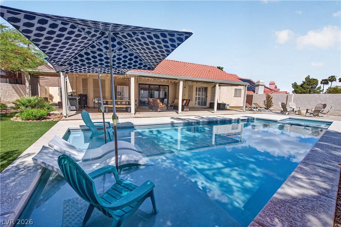1740 Bluffs Drive, Henderson, NV 89014 A sparkling swimming pool serves as the centerpiece of this outdoor entertainment space.