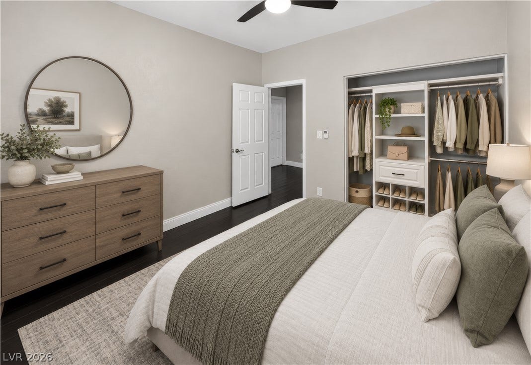 1740 Bluffs Drive, Henderson, NV 89014 This photo is virtually staged. Rich dark wood flooring anchors this serene bedroom complete with custom built-in closet storage.