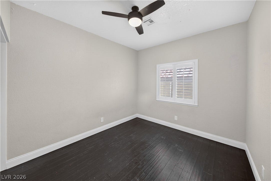 1740 Bluffs Drive, Henderson, NV 89014 Rich dark wood flooring contrasts beautifully with light neutral walls and classic plantation shutters.