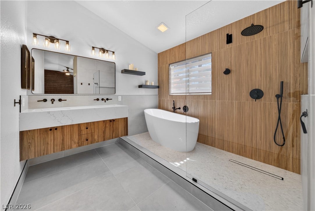 1740 Bluffs Drive, Henderson, NV 89014 A freestanding tub and walk-in shower elevate this contemporary bathroom design.