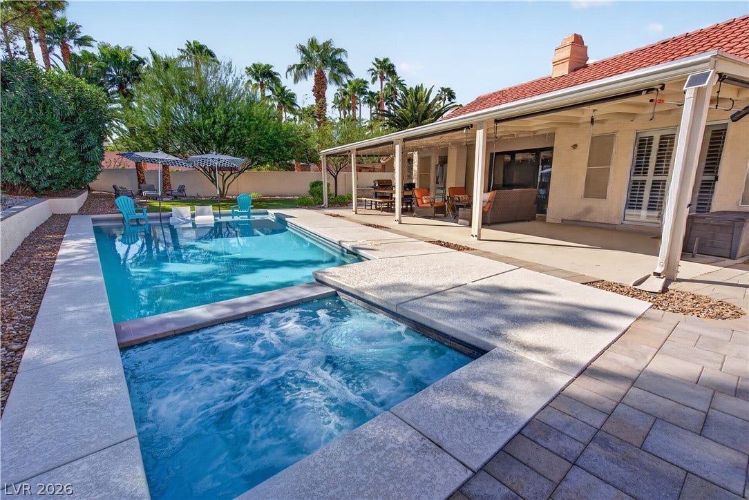 1740 Bluffs Drive, Henderson, NV 89014 A sparkling pool and integrated spa sit adjacent to a spacious covered patio.
