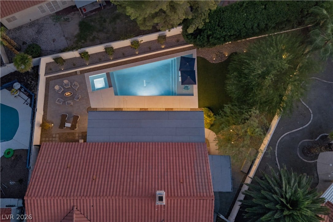 1740 Bluffs Drive, Henderson, NV 89014 An aerial perspective showcases a backyard sanctuary featuring a custom pool and fire pit area.
