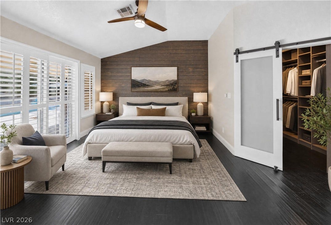 1740 Bluffs Drive, Henderson, NV 89014 A vaulted ceiling and rich dark flooring define this bedroom featuring a built-in walk-in closet.