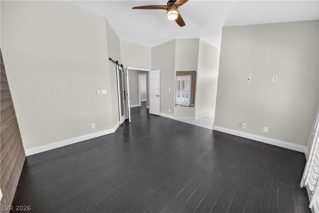 1740 Bluffs Drive, Henderson, NV 89014 Rich dark wood flooring complements the vaulted ceiling of this versatile living space.