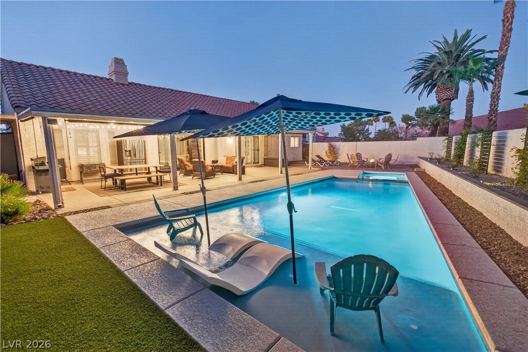 1740 Bluffs Drive, Henderson, NV 89014 An inviting swimming pool and covered patio highlight the backyard of this tile-roofed home.