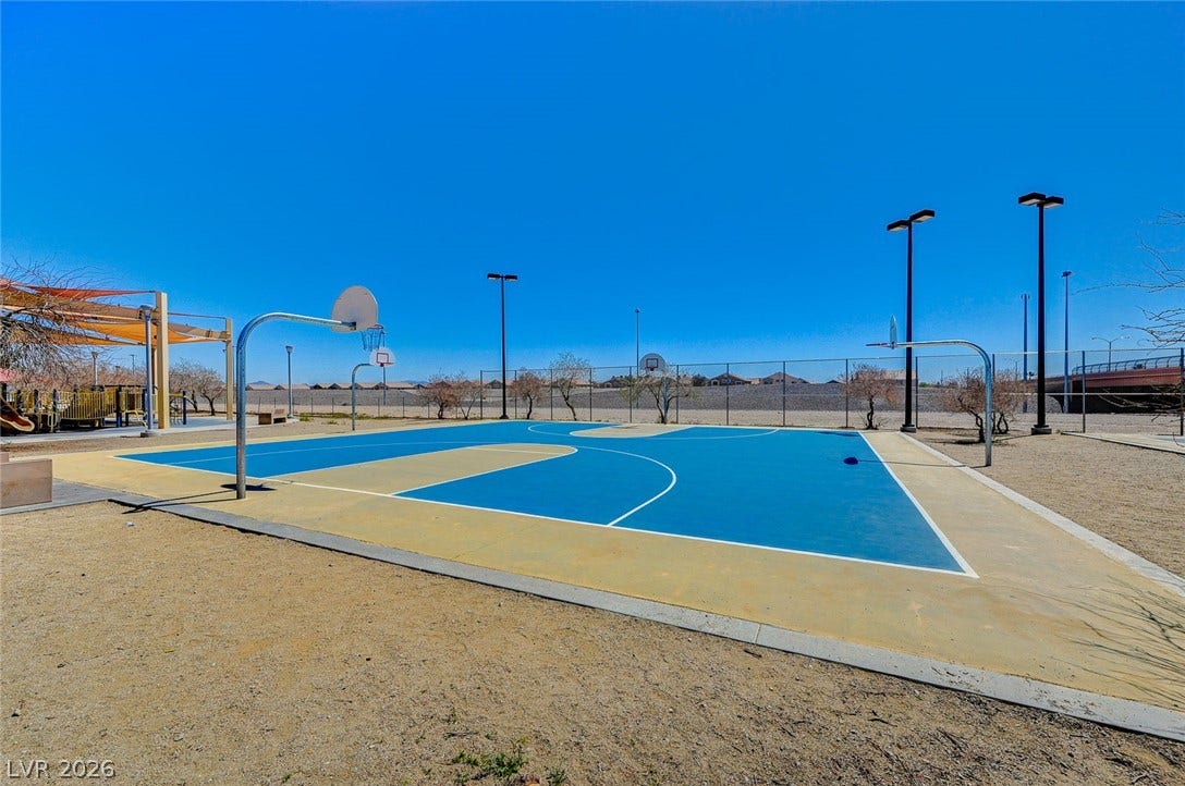 4120 Hawks Glide Avenue, North Las Vegas, NV 89084 An outdoor basketball court stands ready for play under wide, clear blue skies.