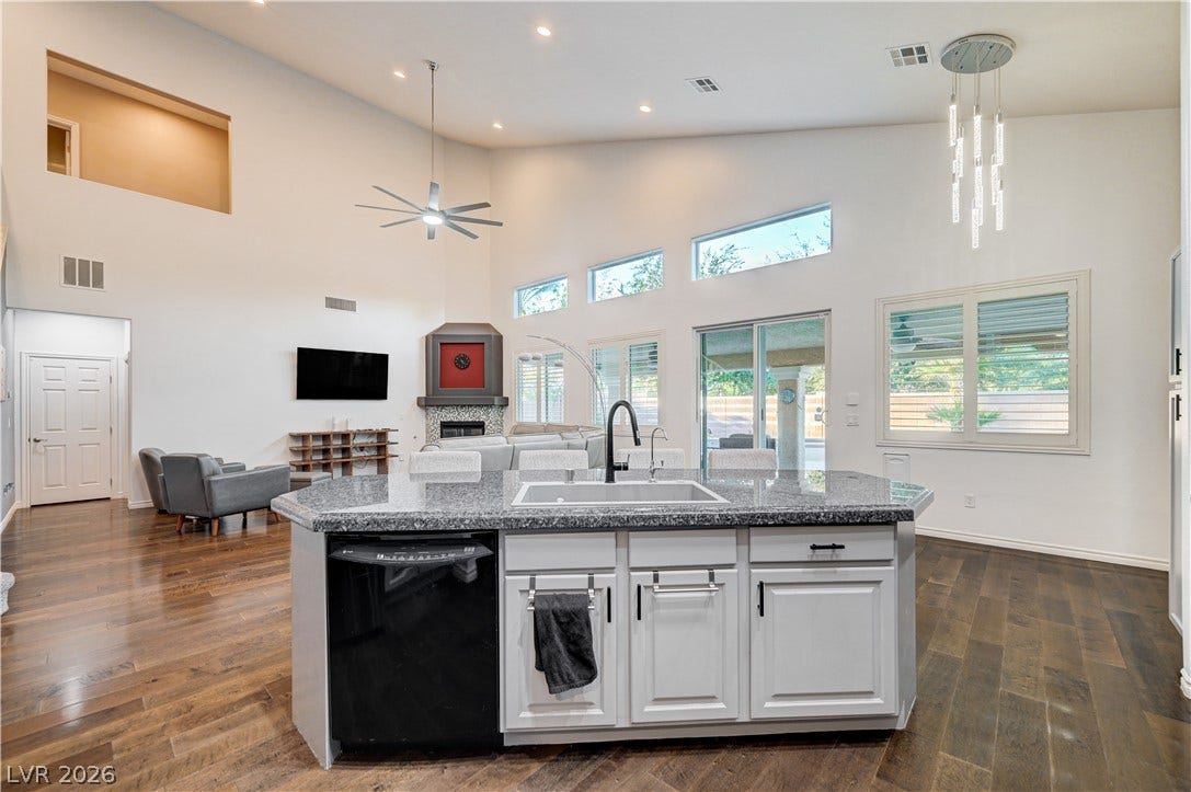 4120 Hawks Glide Avenue, North Las Vegas, NV 89084 Soaring ceilings and rich wood floors anchor this expansive open-concept main living and cooking space.