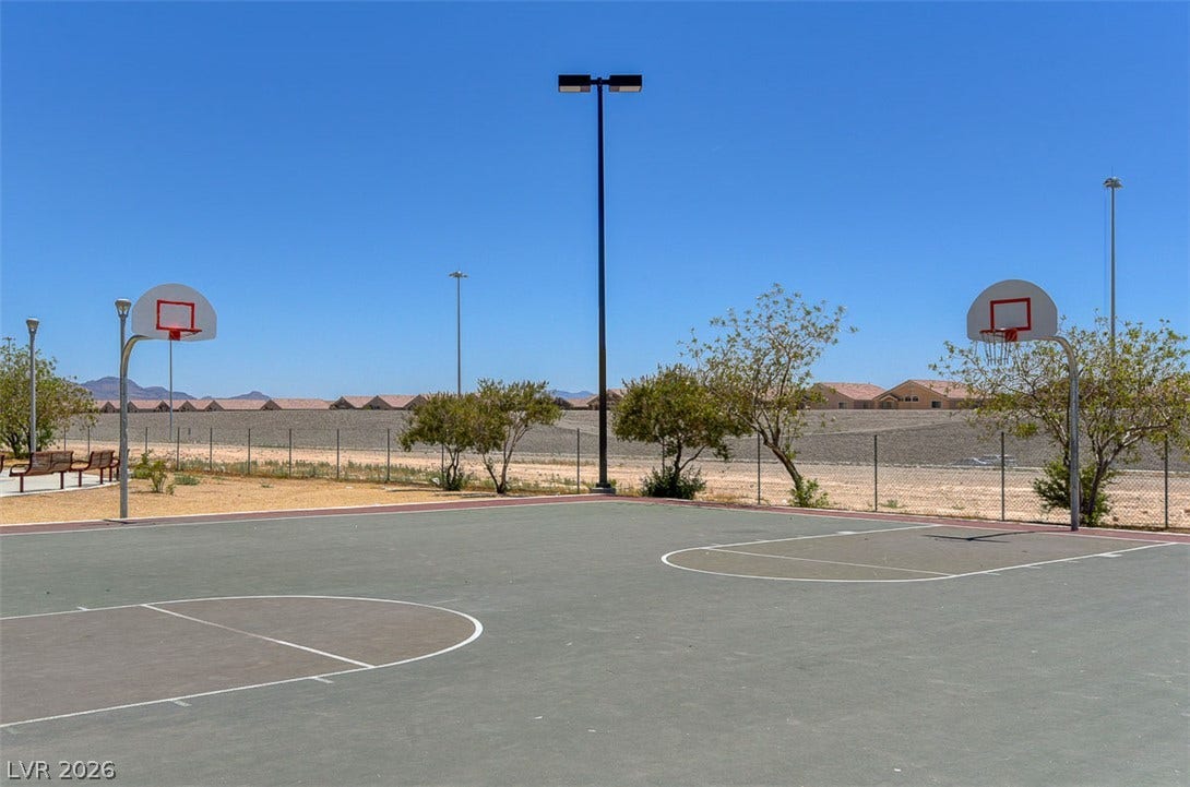 4120 Hawks Glide Avenue, North Las Vegas, NV 89084 An outdoor basketball court stands ready for play under a clear blue sky.