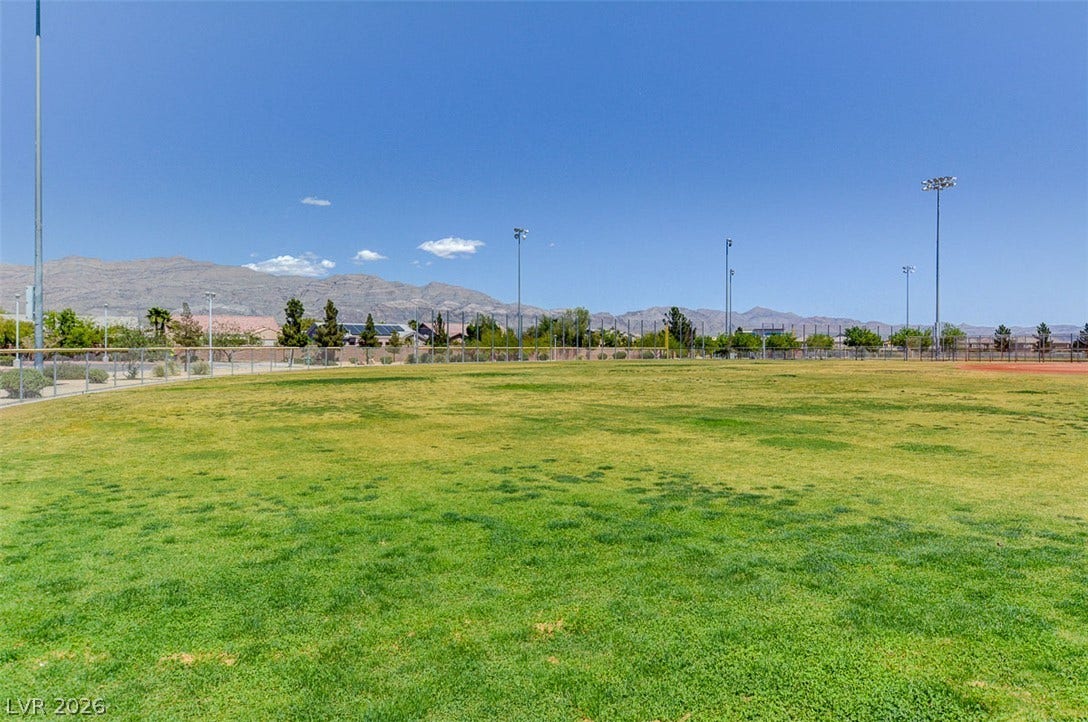 4120 Hawks Glide Avenue, North Las Vegas, NV 89084 A spacious grassy community park offers mountain views under clear desert skies.