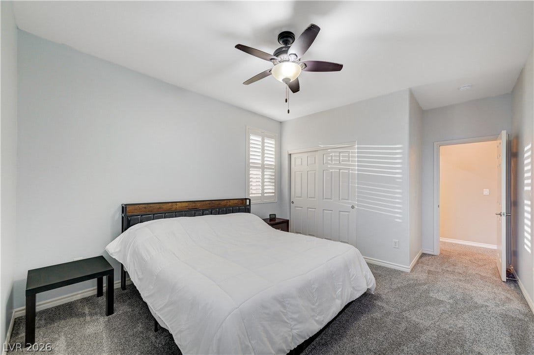 4120 Hawks Glide Avenue, North Las Vegas, NV 89084 Plush carpeting anchors this peaceful bedroom retreat featuring classic plantation shutters.