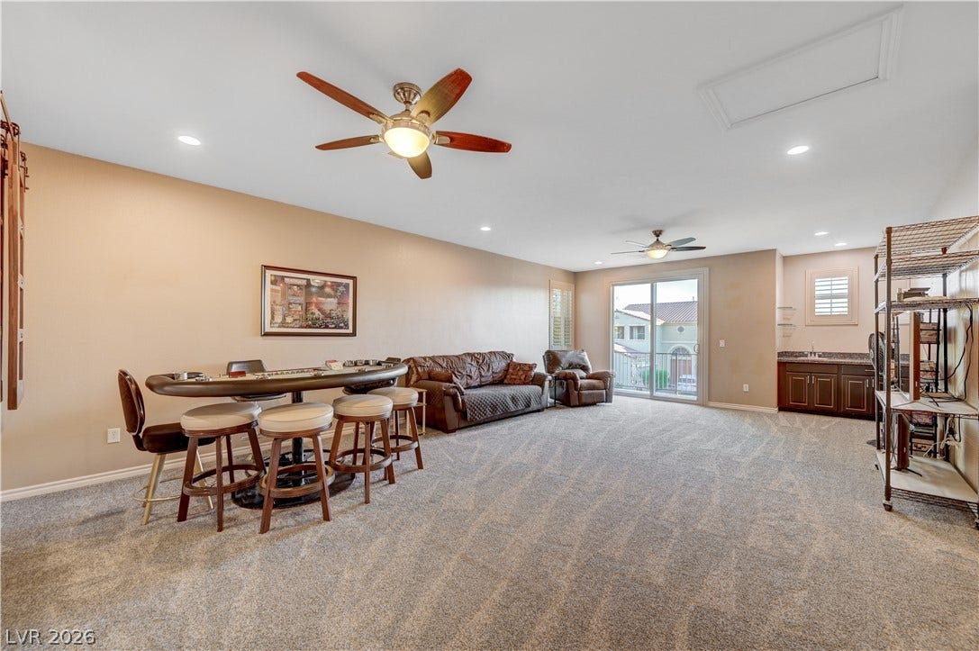 4120 Hawks Glide Avenue, North Las Vegas, NV 89084 Plush carpeting anchors this expansive recreation room complete with a built-in wet bar.