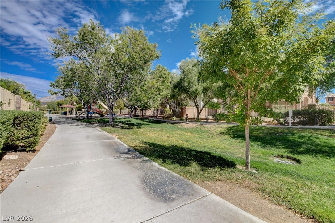 4120 Hawks Glide Avenue, North Las Vegas, NV 89084 Paved walking paths wind through beautifully landscaped green spaces alongside neighborhood trees and play structures.