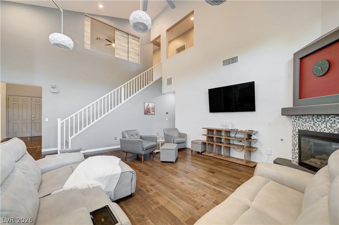 4120 Hawks Glide Avenue, North Las Vegas, NV 89084 Hardwood floors and towering ceilings frame this expansive living area.