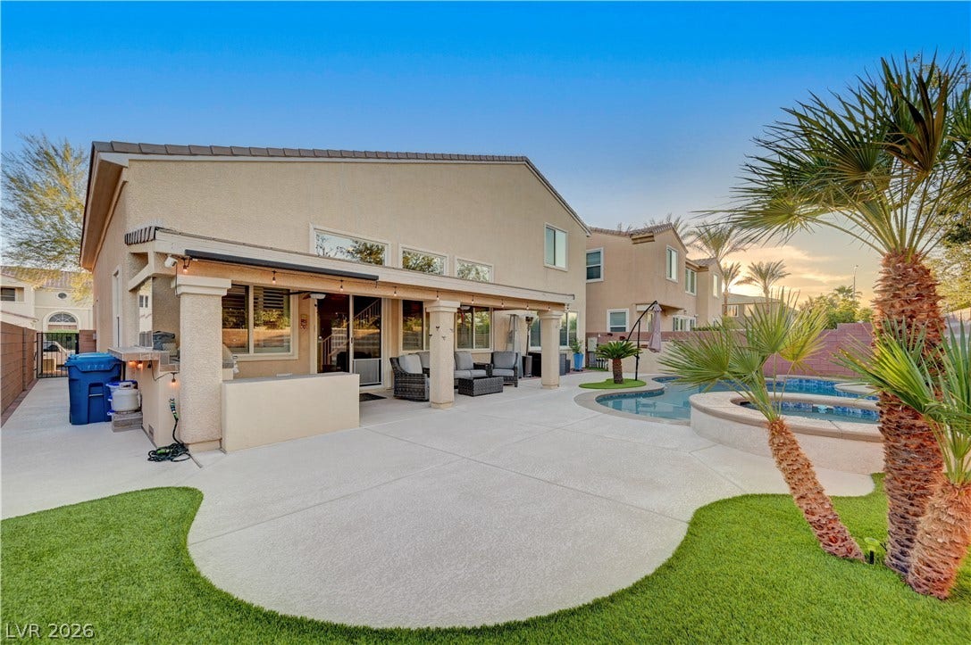 4120 Hawks Glide Avenue, North Las Vegas, NV 89084 An inviting backyard oasis features a covered patio alongside a sparkling pool and spa.