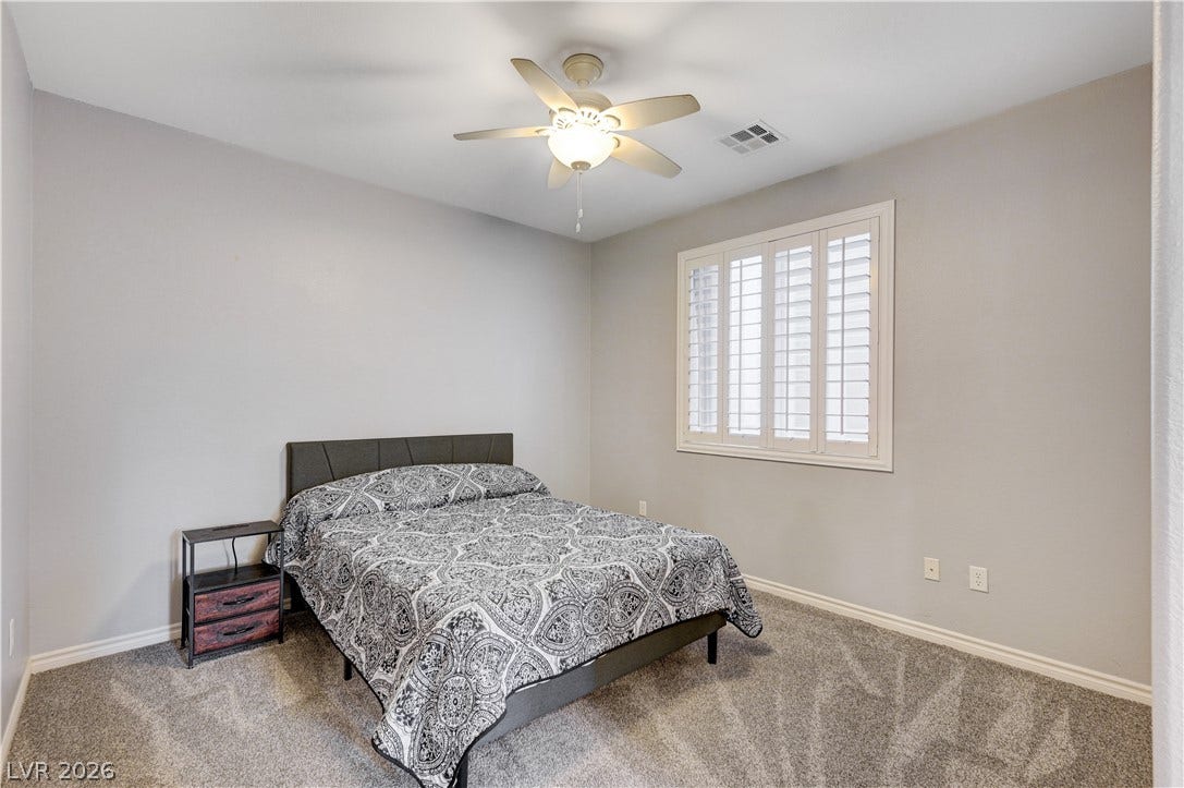 4120 Hawks Glide Avenue, North Las Vegas, NV 89084 Plush carpeting and plantation shutters define this cozy bedroom retreat.