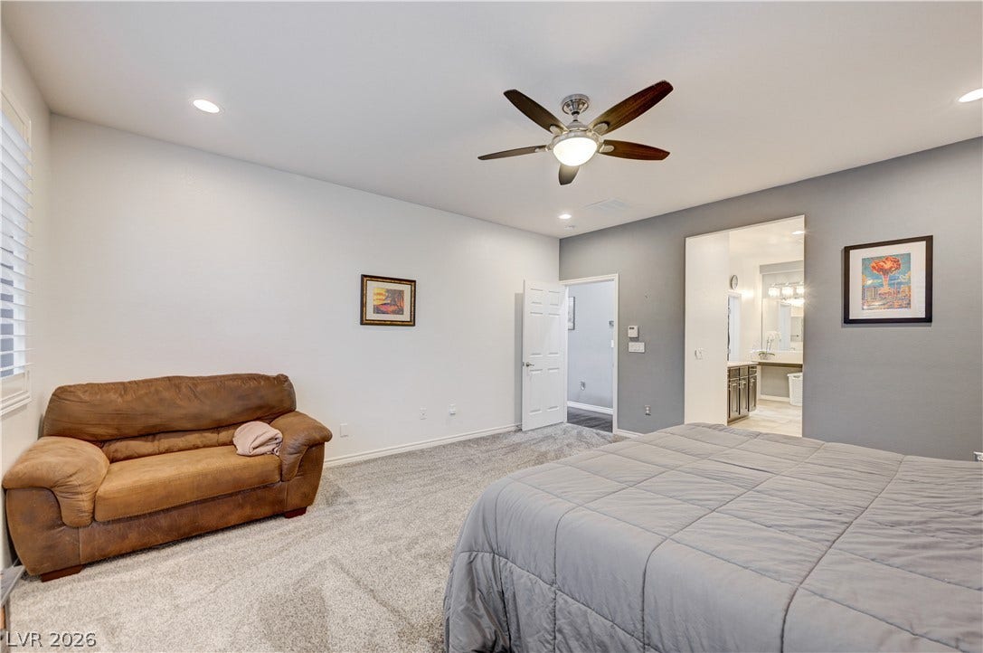 4120 Hawks Glide Avenue, North Las Vegas, NV 89084 A spacious bedroom features plush carpeting, recessed lighting, and access to an adjoining bathroom.
