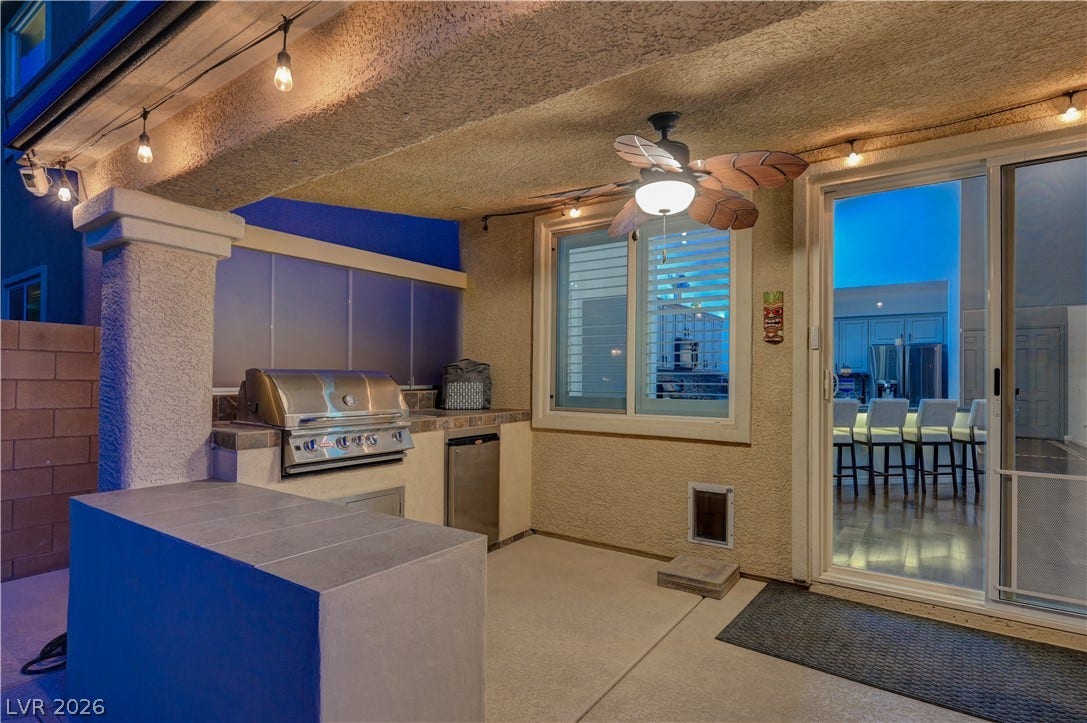 4120 Hawks Glide Avenue, North Las Vegas, NV 89084 An inviting covered patio offers a tiled bar and built-in grill area for effortless entertaining.