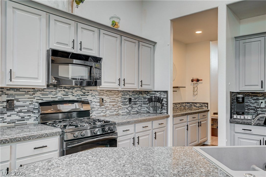 4120 Hawks Glide Avenue, North Las Vegas, NV 89084 Polished granite countertops complement classic cabinetry and modern stainless steel appliances.