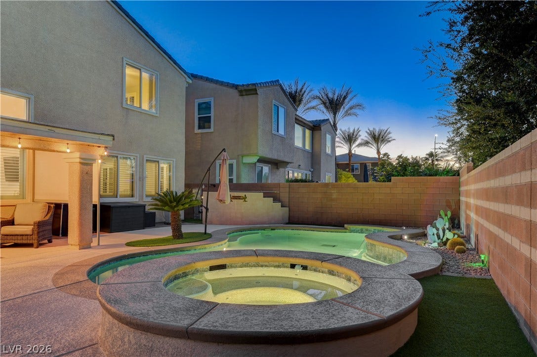 4120 Hawks Glide Avenue, North Las Vegas, NV 89084 An inviting backyard oasis showcases a custom swimming pool with an integrated raised spa.