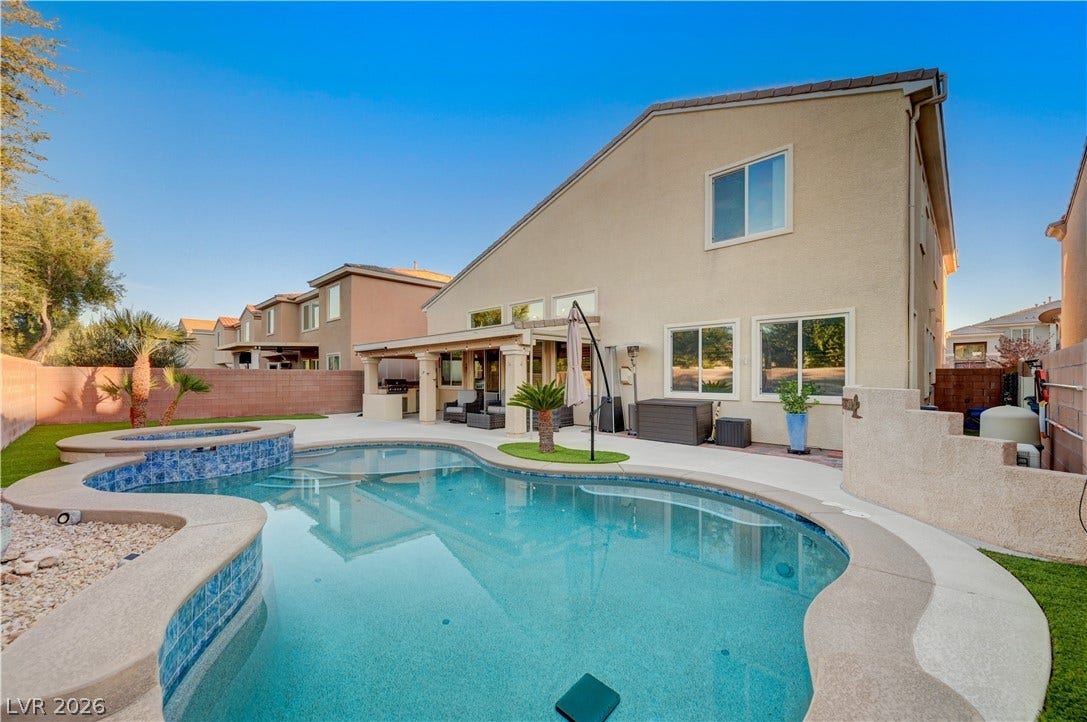 4120 Hawks Glide Avenue, North Las Vegas, NV 89084 A sparkling freeform pool and elevated spa anchor this low-maintenance backyard retreat.