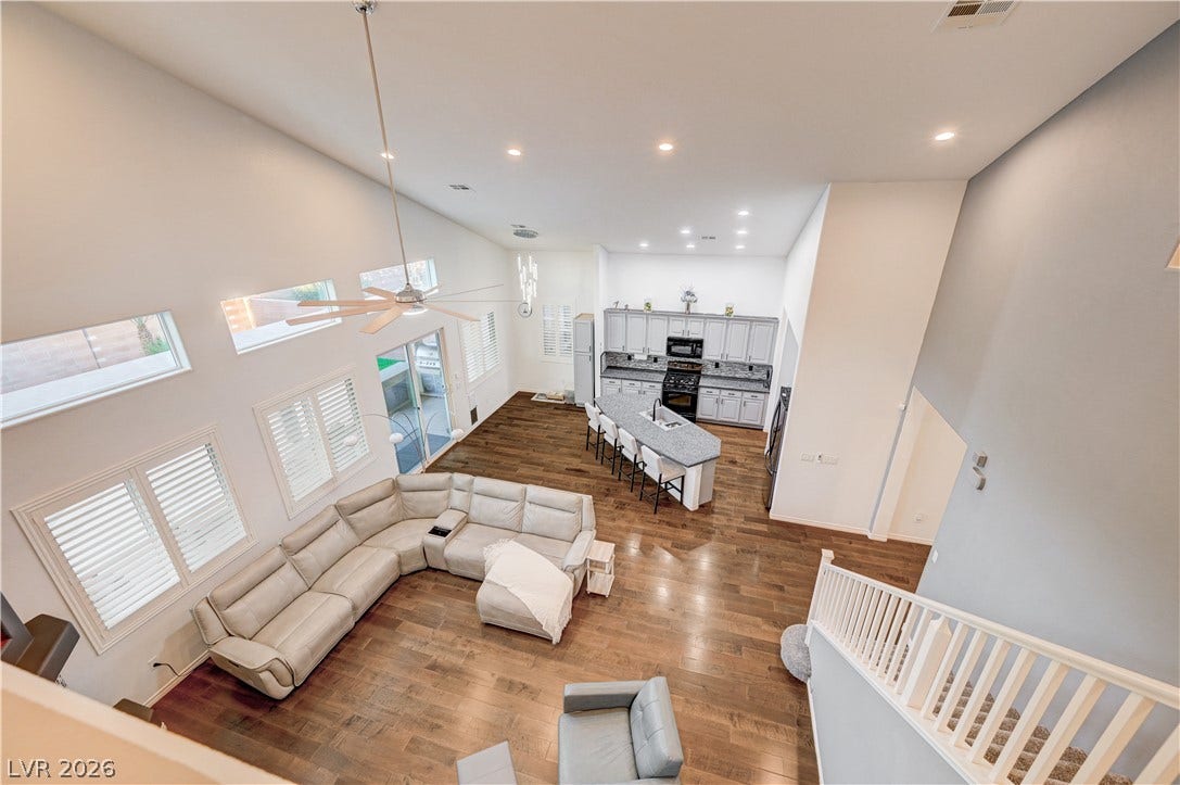 4120 Hawks Glide Avenue, North Las Vegas, NV 89084 Hardwood floors and vaulted ceilings define this airy, open-concept living space and kitchen.
