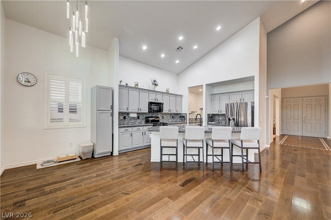 4120 Hawks Glide Avenue, North Las Vegas, NV 89084 Soaring vaulted ceilings and rich wood floors frame this gourmet open-concept kitchen.