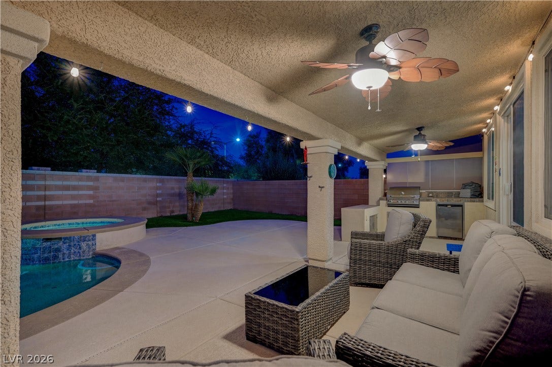 4120 Hawks Glide Avenue, North Las Vegas, NV 89084 A spacious covered patio leads directly to the backyard pool and built-in outdoor kitchen.