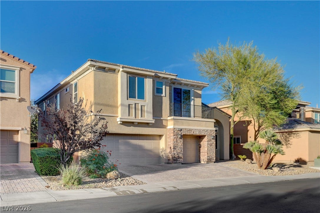 4120 Hawks Glide Avenue, North Las Vegas, NV 89084 Stone accents and a private balcony enhance this two-story home with a paved driveway.