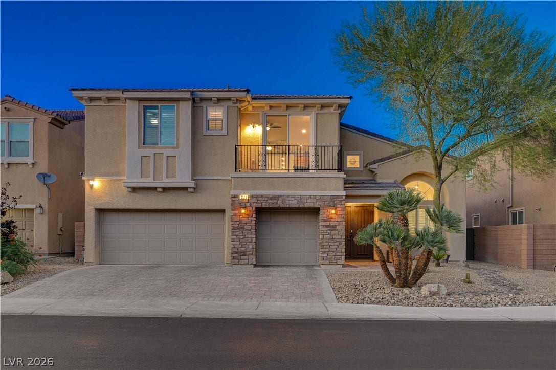 4120 Hawks Glide Avenue, North Las Vegas, NV 89084 Stone accents and a paved driveway complement this two-story exterior at twilight.