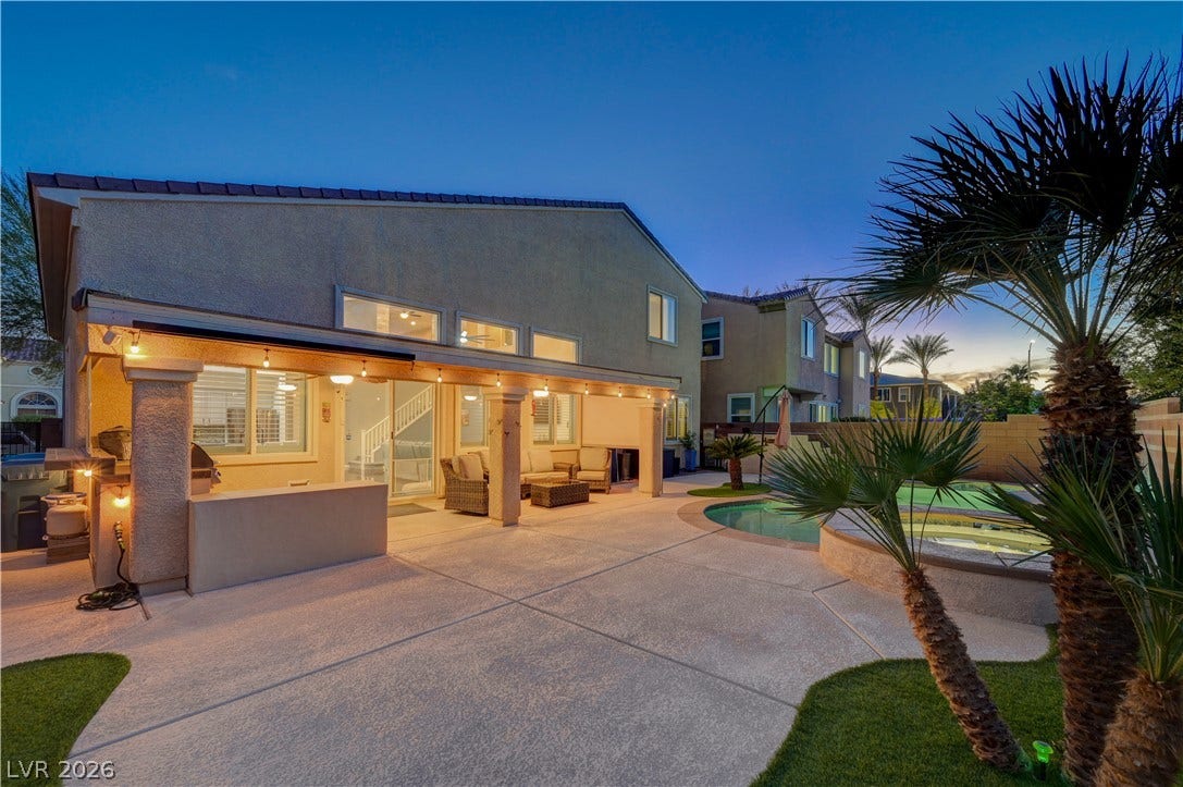 4120 Hawks Glide Avenue, North Las Vegas, NV 89084 A spacious covered patio integrates seamlessly with the backyard pool area for effortless outdoor living.