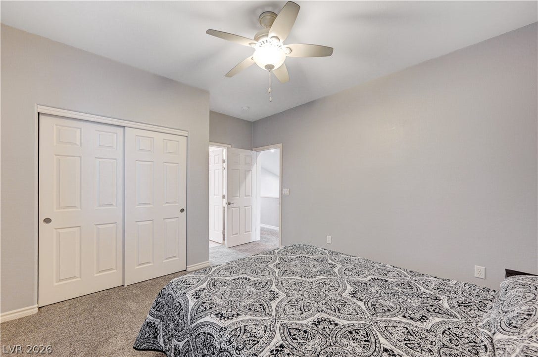 4120 Hawks Glide Avenue, North Las Vegas, NV 89084 Plush carpeting anchors this quiet bedroom space featuring ample closet storage.
