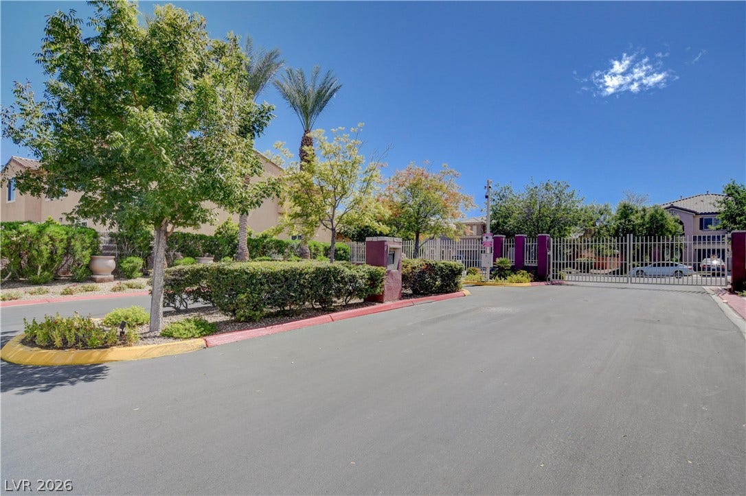 4120 Hawks Glide Avenue, North Las Vegas, NV 89084 Secure gated entry welcomes residents home amidst manicured landscaping and mature trees.