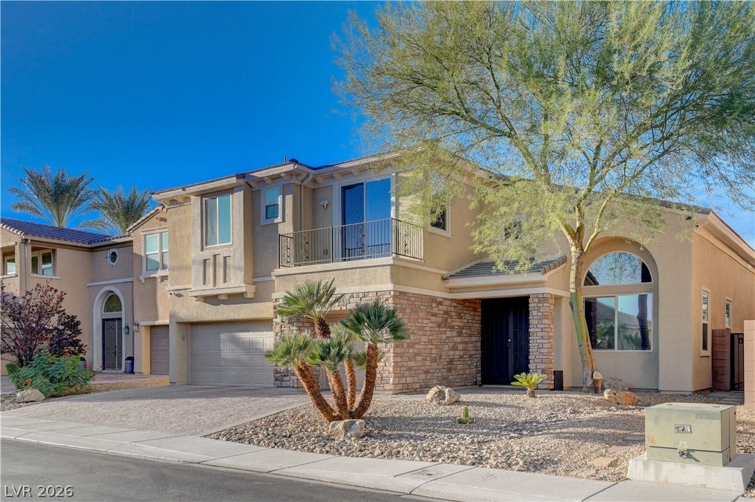 4120 Hawks Glide Avenue, North Las Vegas, NV 89084 Stone accents and desert landscaping enhance the exterior design of this multi-level home.