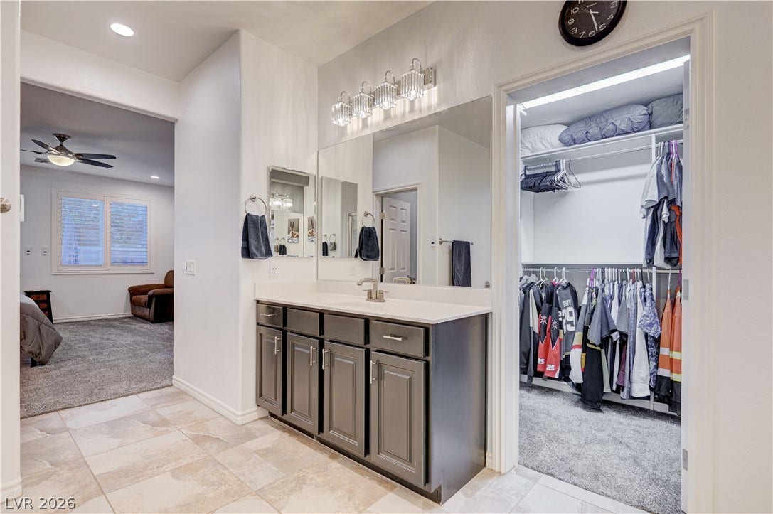 4120 Hawks Glide Avenue, North Las Vegas, NV 89084 A spacious vanity area connects seamlessly to a walk-in closet and carpeted bedroom.