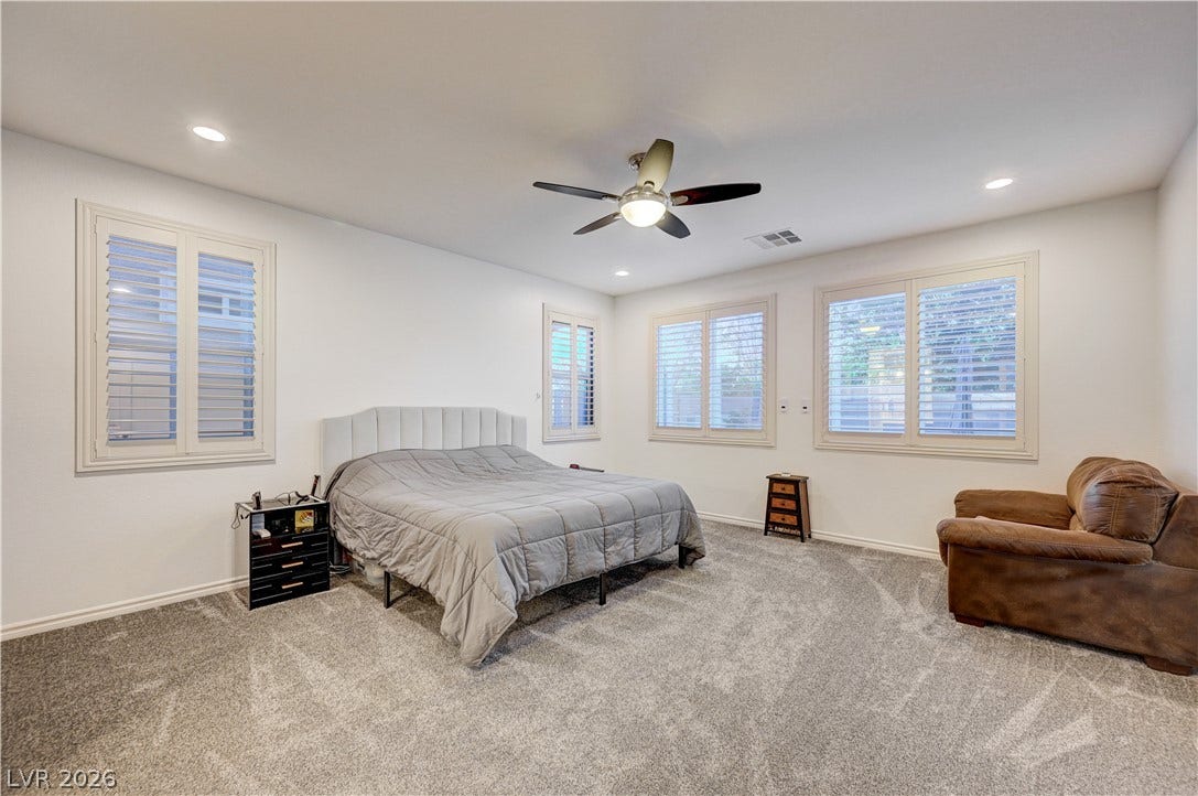 4120 Hawks Glide Avenue, North Las Vegas, NV 89084 Plentiful windows with integrated shutters and soft carpeting define this comfortable bedroom space.
