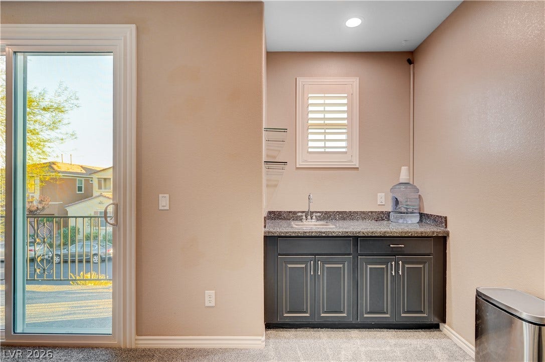 4120 Hawks Glide Avenue, North Las Vegas, NV 89084 A convenient wet bar highlights this versatile space adjacent to a sliding glass door.