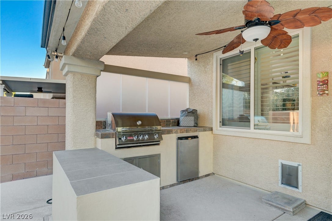 4120 Hawks Glide Avenue, North Las Vegas, NV 89084 A covered concrete patio includes a built-in outdoor kitchen with a gas grill.
