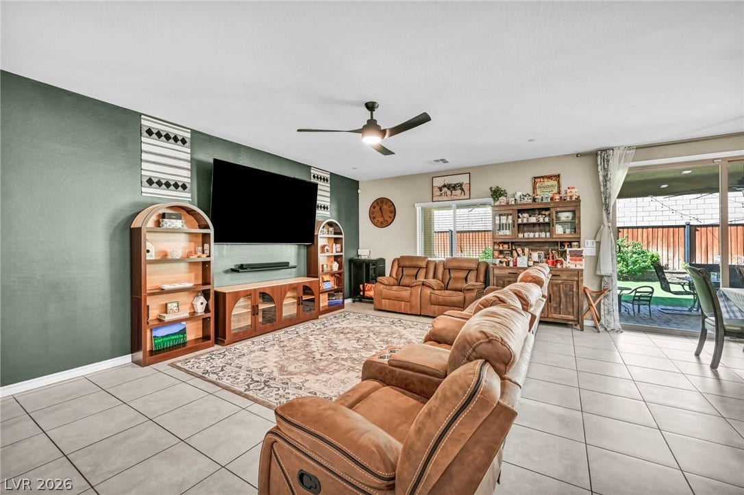 Polished tile flooring and sliding glass doors enhance this welcoming living space.