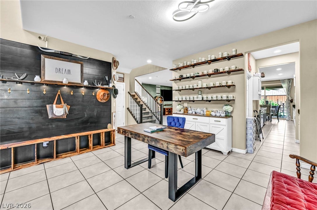 Tiled floors and built-in features anchor this versatile open entryway.