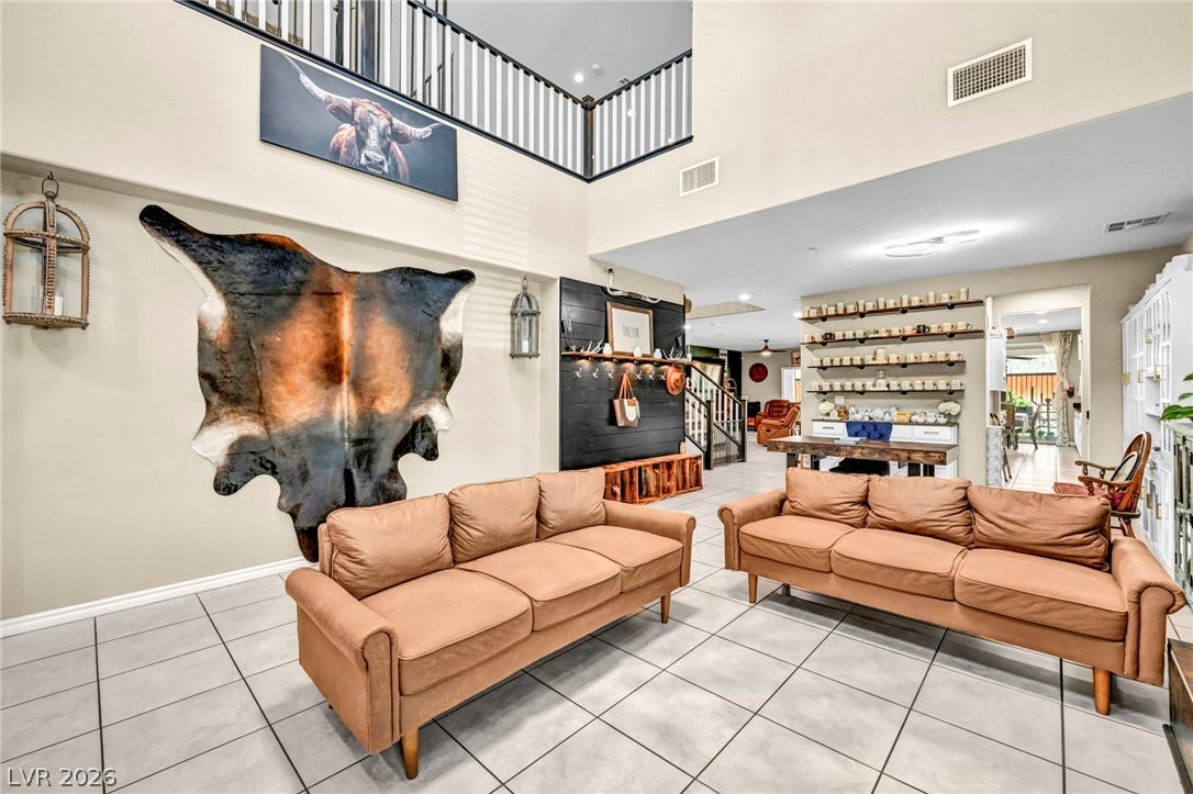 Gleaming tile floors and soaring high ceilings define this grand, open living space.