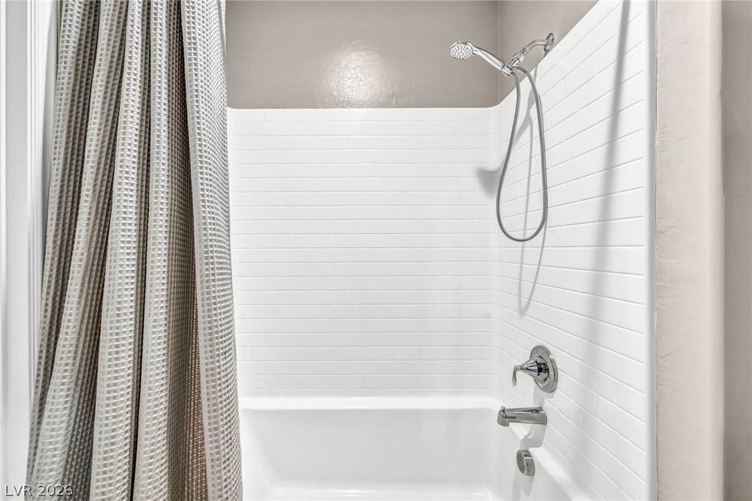 Crisp subway tile surrounds this classic tub and shower combination.